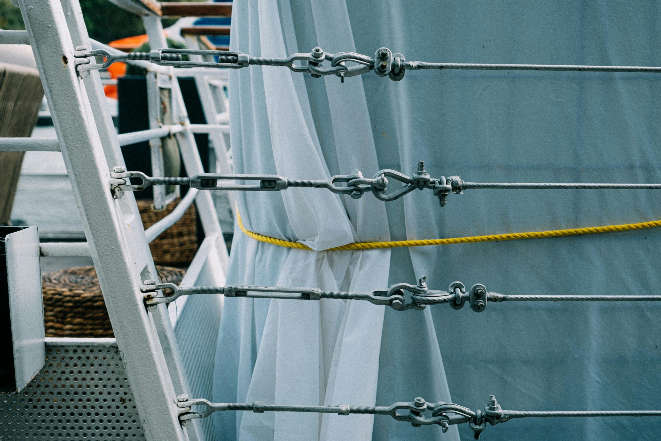 Detailed view of ship rigging with fabric and ropes, showcasing marine equipment.